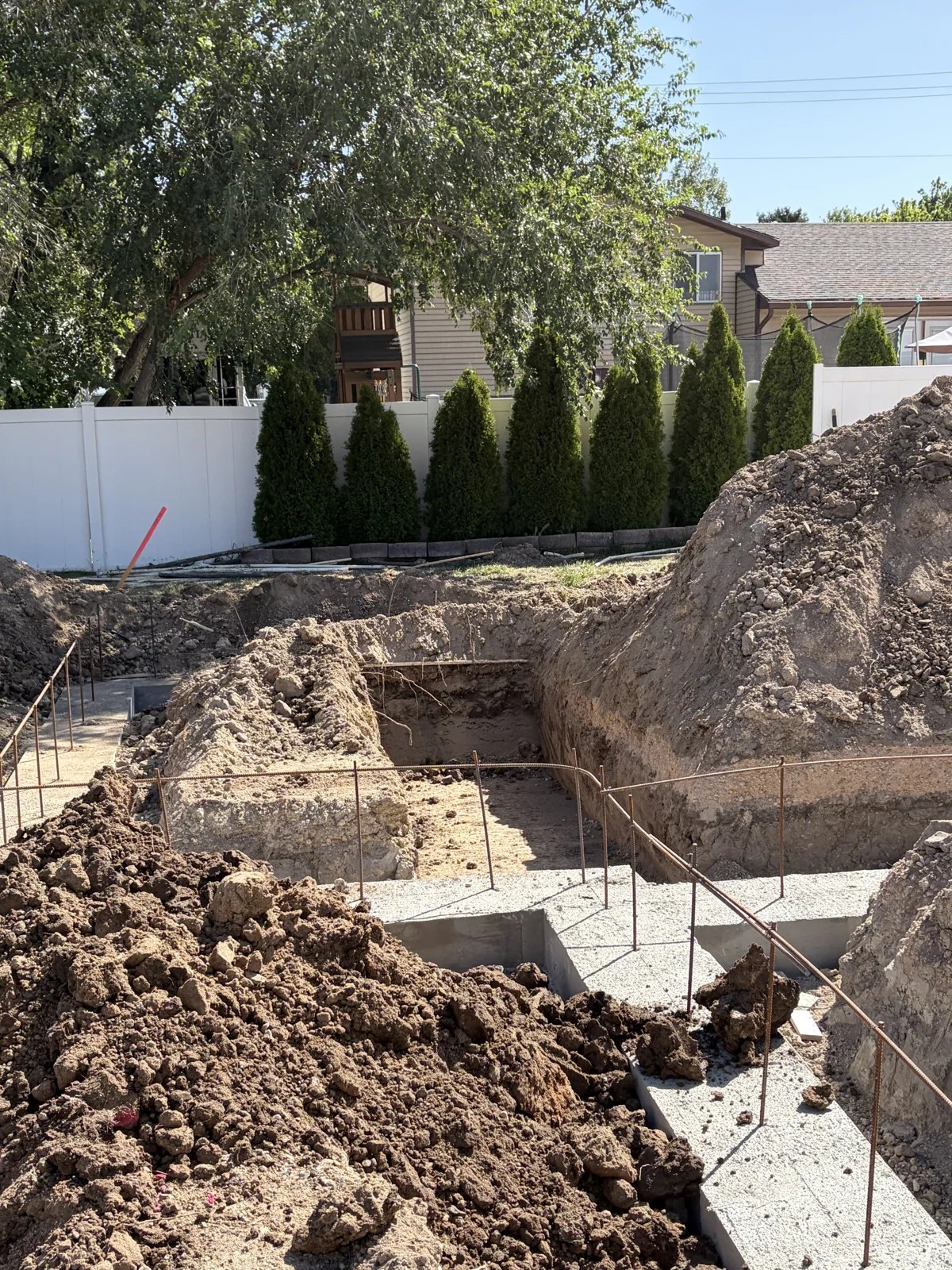 Footings formed and reinforced in an open foundation excavation